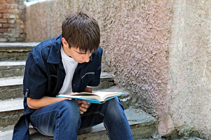 Teen boy reading Bible