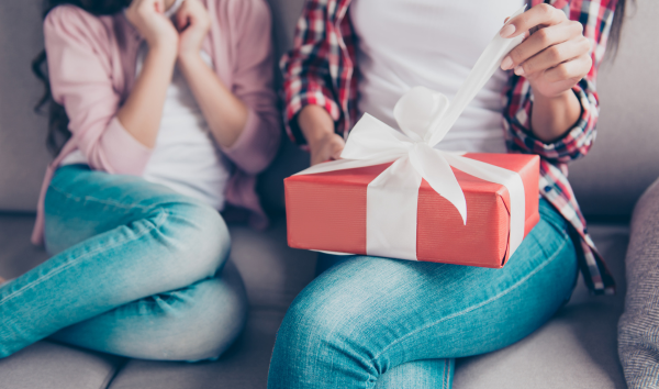 two girls opening gifts