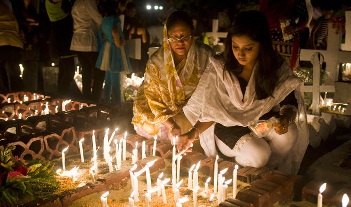 Catholics pray at a shrine to souls gone before