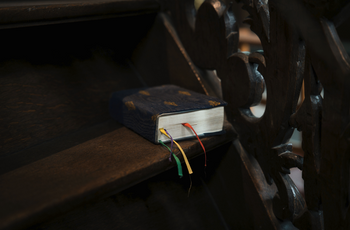 Book of prayer in a pew.